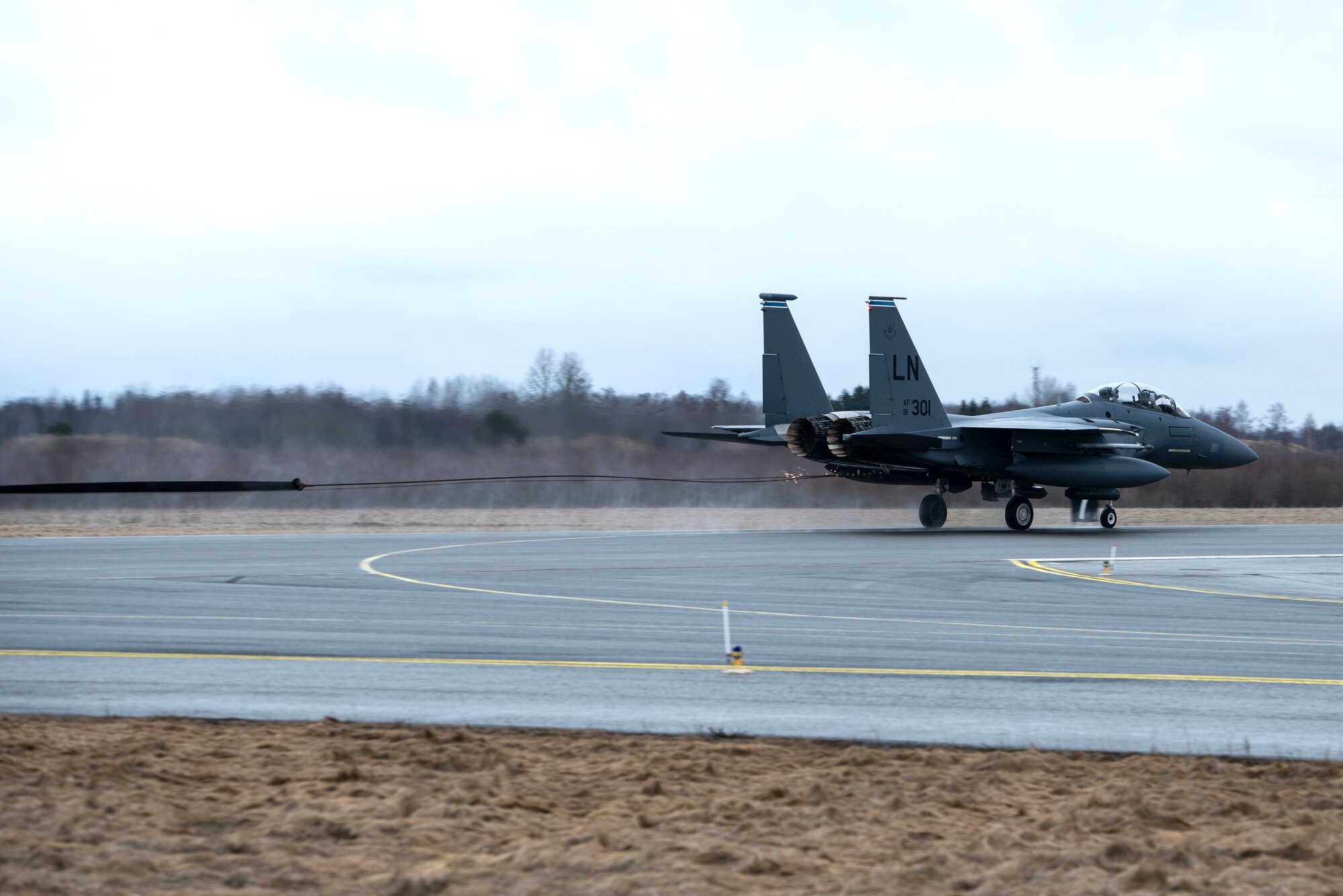 An F-15E Strike Eagle assigned to the 492nd Fighter Squadron catches the cable of an aircraft arresting system during a Barrier Arresting Kit certification at Ämari Air Base, Estonia, March 17, 2021. An aircraft arresting system is in place to bring aircraft to a safe stop in the event of an emergency that would prevent the aircraft from performing a standard landing. (U.S. Air Force photo by Airman 1st Class Jessi Monte)