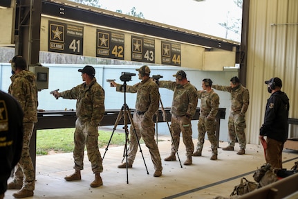 Service Members from across the Army, Army Reserves and National Guard fire M-9 pistols during the 2021 U.S. Army “All Army” Small Arms Championships at Fort Benning, Georgia, March 14-20, 2021. National Guard teams and individuals brought home 23 of 31 top awards including 1st in nine of 11 categories.