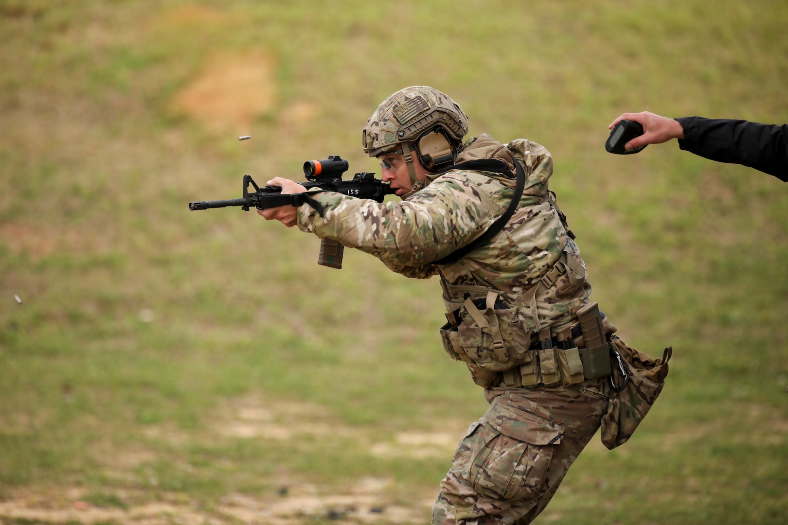 Sgt. 1st Class Chris Catlin, an infantryman with the Colorado National Guard’s Centennial Training Site, fires his M4 carbine while a grader keeps time during the multi-gun match at the 2021 U.S. Army “All Army” Small Arms Championships at Fort Benning, Georgia, March 14-20, 2021.