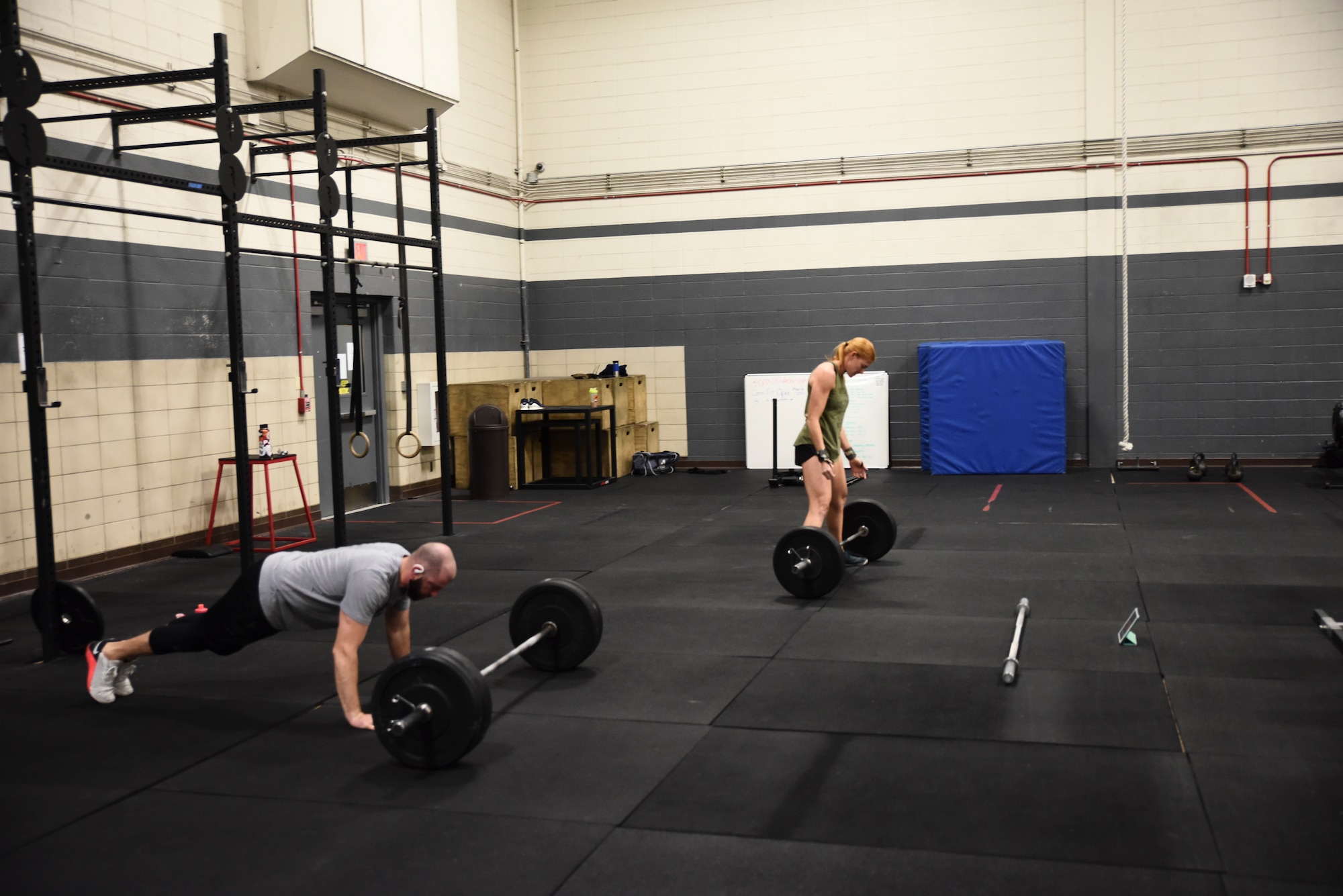 A picture of an athlete in the weight room performing power cleans.