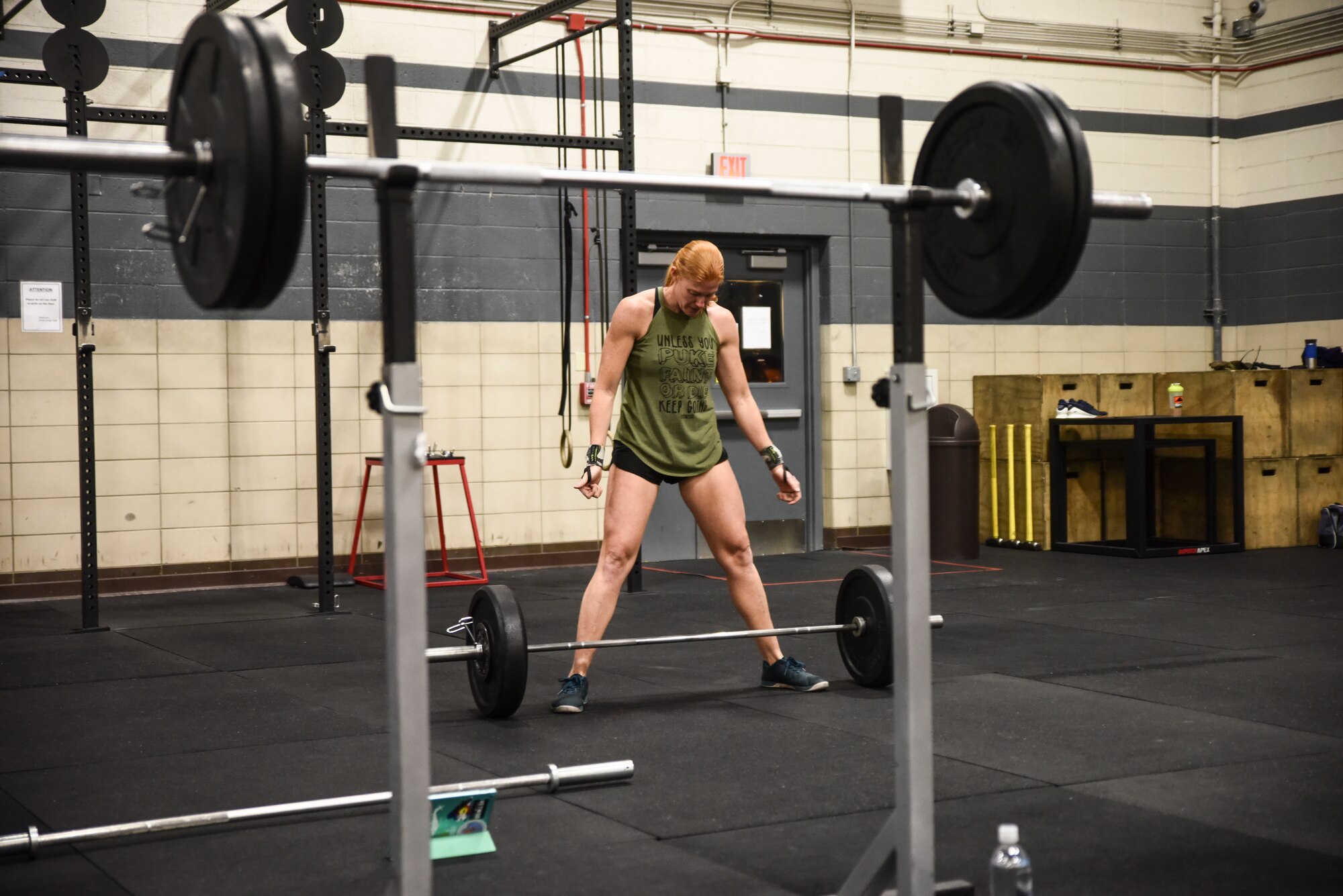 A picture of an athlete in the weight room performing power cleans.