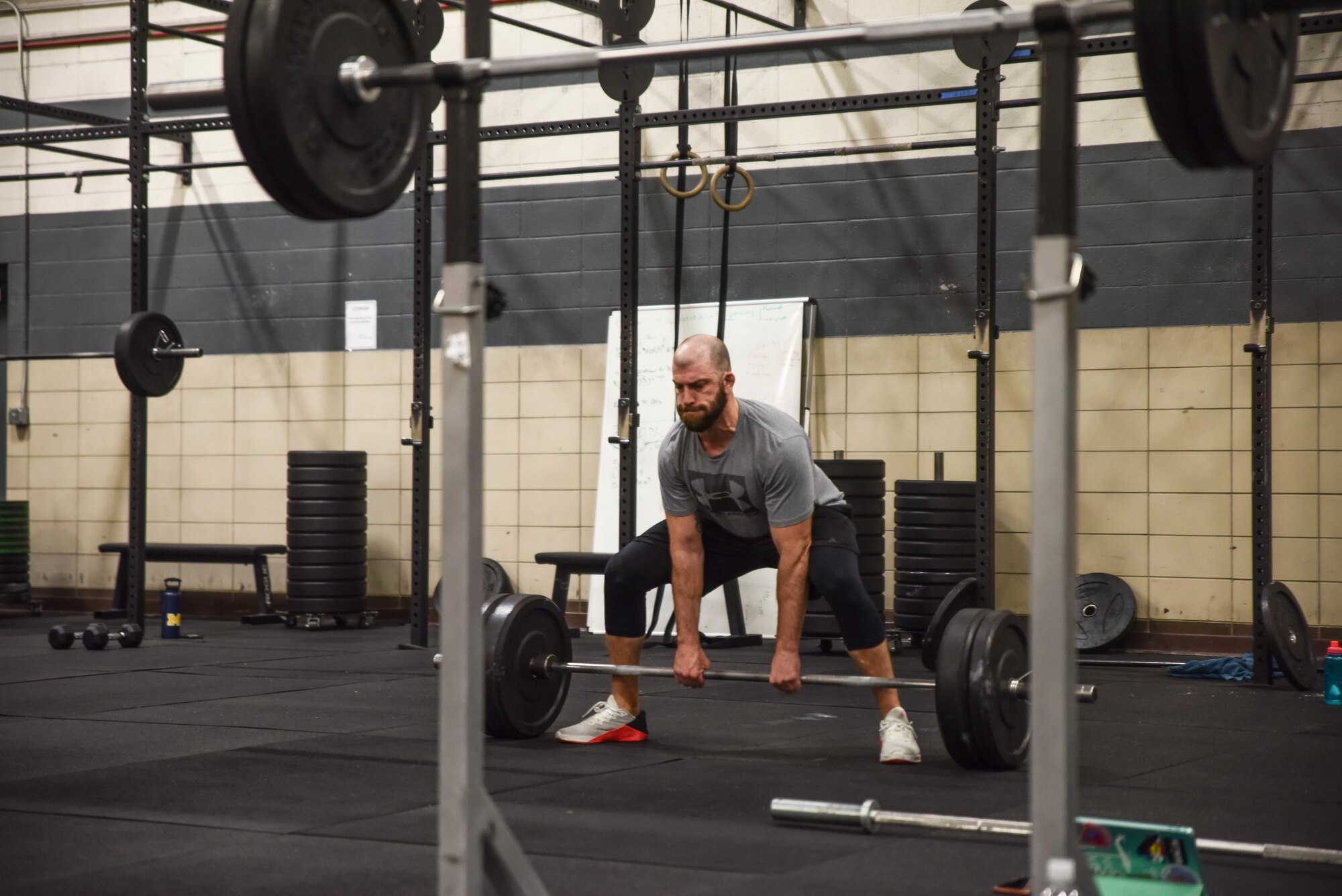 A picture of an athlete in the weight room performing power cleans.