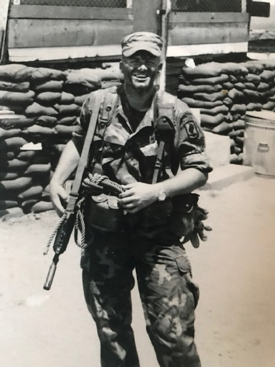 A man in Army battle dress poses for a photo.