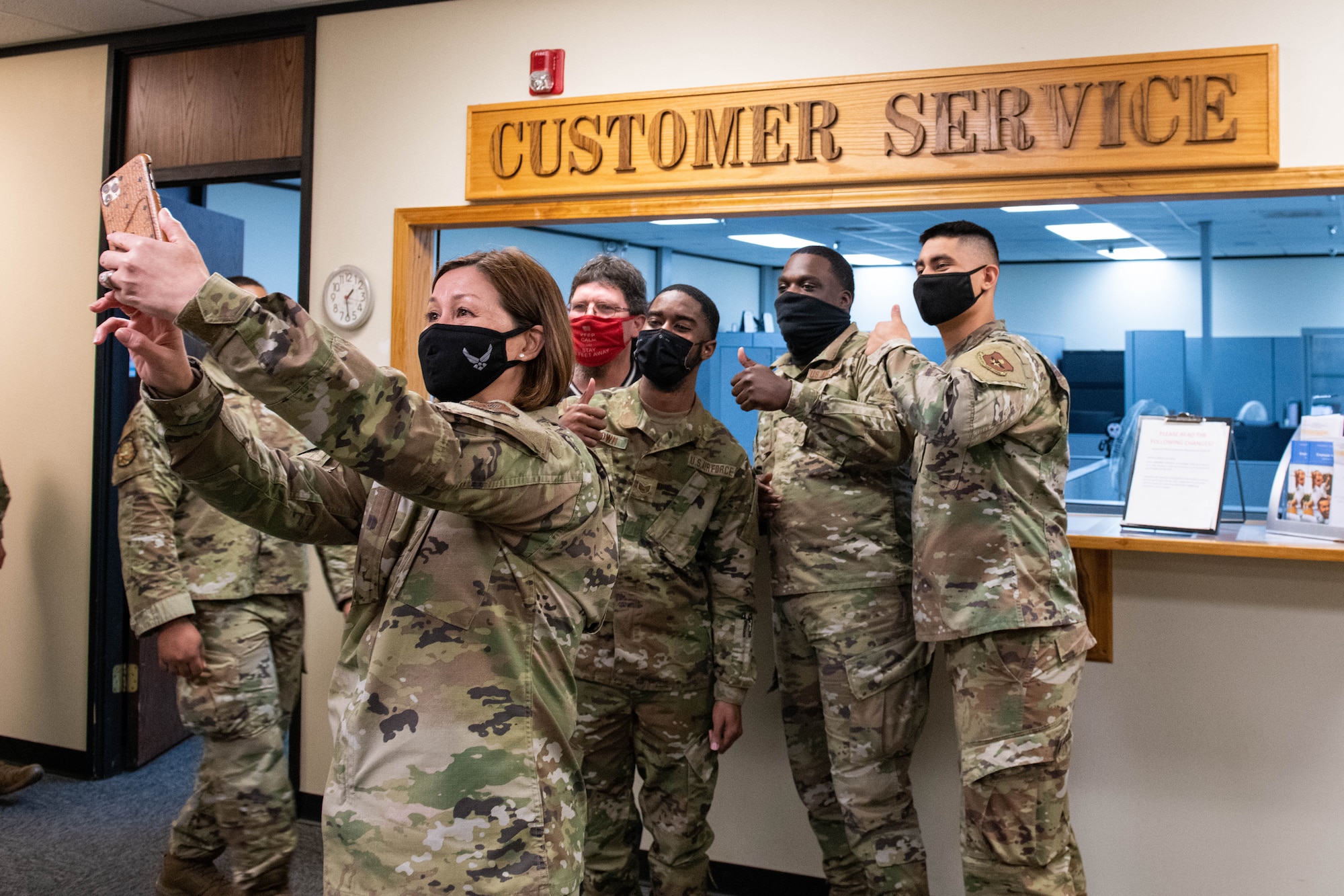 Chief Master Sergeant of the Air Force JoAnne S. Bass takes a photo with Airmen from the 97th Force Support Squadron Military Personnel Flight during a tour, March 22, 2021, at Altus Air Force Base, Okla. Bass visited Altus AFB and took the time to share her thoughts on the value of diversity, how it contributes to an environment of belonging, and ultimately, increased readiness.