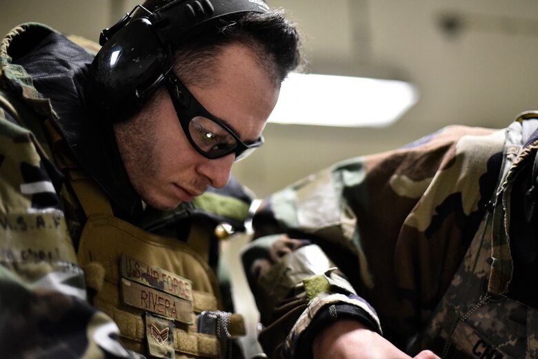 Airmen use tools to repair an aircraft component.