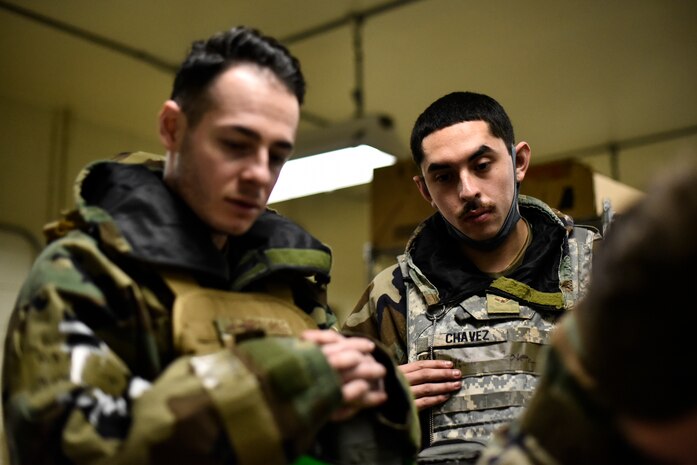 Airmen use tools to repair an aircraft component.