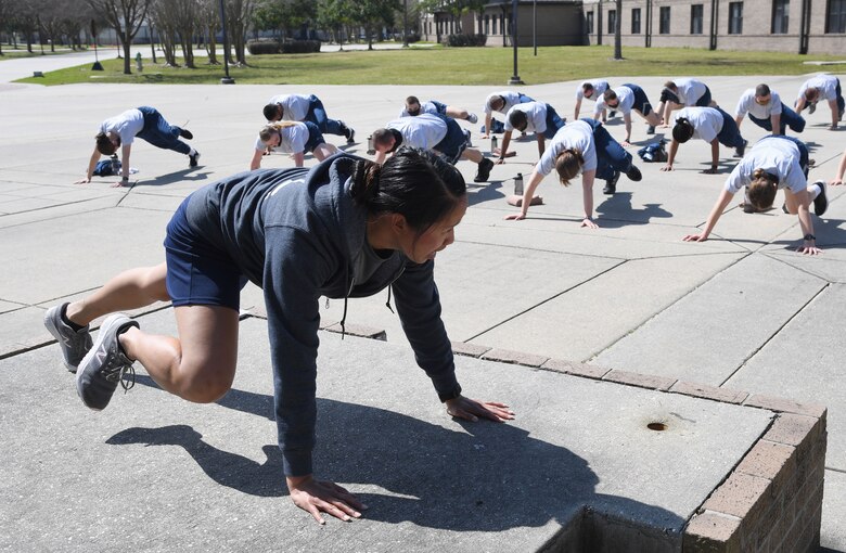 U.S. Air Force Staff Sgt. Faustina Lai, 81st Training Support Squadron military training leader school instructor, leads a physical training session at Keesler Air Force Base, Mississippi, Feb. 25, 2021. The Master Military Training Leader Program, created at Keesler, was designed to distinguish the military training leaders who have mastered the demonstration, evaluation and reinforcement of military standards; exude military bearing and discipline while scheduling and conducting military training; and are key leaders among Airmen and their peers. (U.S. Air Force photo by Kemberly Groue)