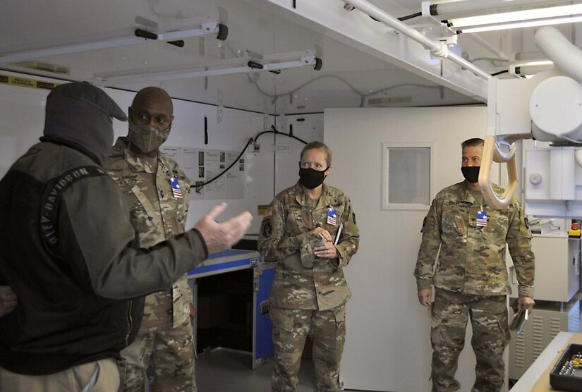 Maj. Gen. Mitchell Kilgo, second from left, commanding general of U.S. Army Communications-Electronics Command, listens to a staff briefing during a Feb. 24 visit to the U.S. Army Medical Materiel Agency’s Medical Maintenance Operations Division at Tracy, California. Also pictured are CECOM Command Sgt. Maj. Kristie Brady and USAMMA Commander Col. John “Ryan” Bailey. (Photo Credit: Jowel A. Liwanag)