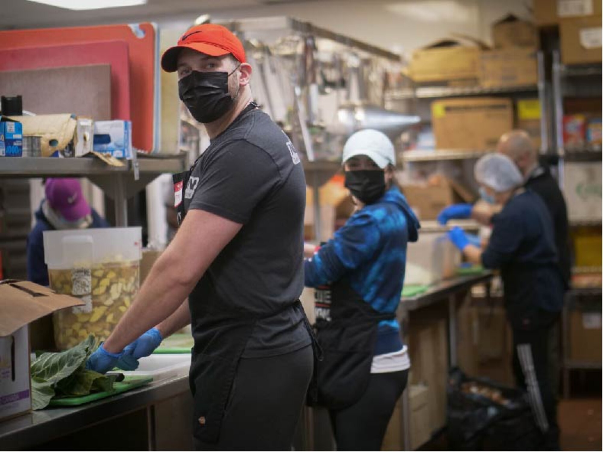 U.S. Air Force Staff Sgt. Jimmy Mrosko, an Air Guard and Reserve assignment technician, and his wife, Staff Sgt. Ashlee Sandefur, a Command Support Staff team member, both at Headquarters Air Reserve Personnel Center, prepares meals at Denver Rescue Mission Feb. 21, 2021, in Denver, Colo. Mrosko led the charge of developing a volunteer team from HQ ARPC in serving the 6,104 homeless persons of the Denver community on a bimonthly basis. (U.S. Air Force photo by Master Sgt. Leisa Grant/Released)