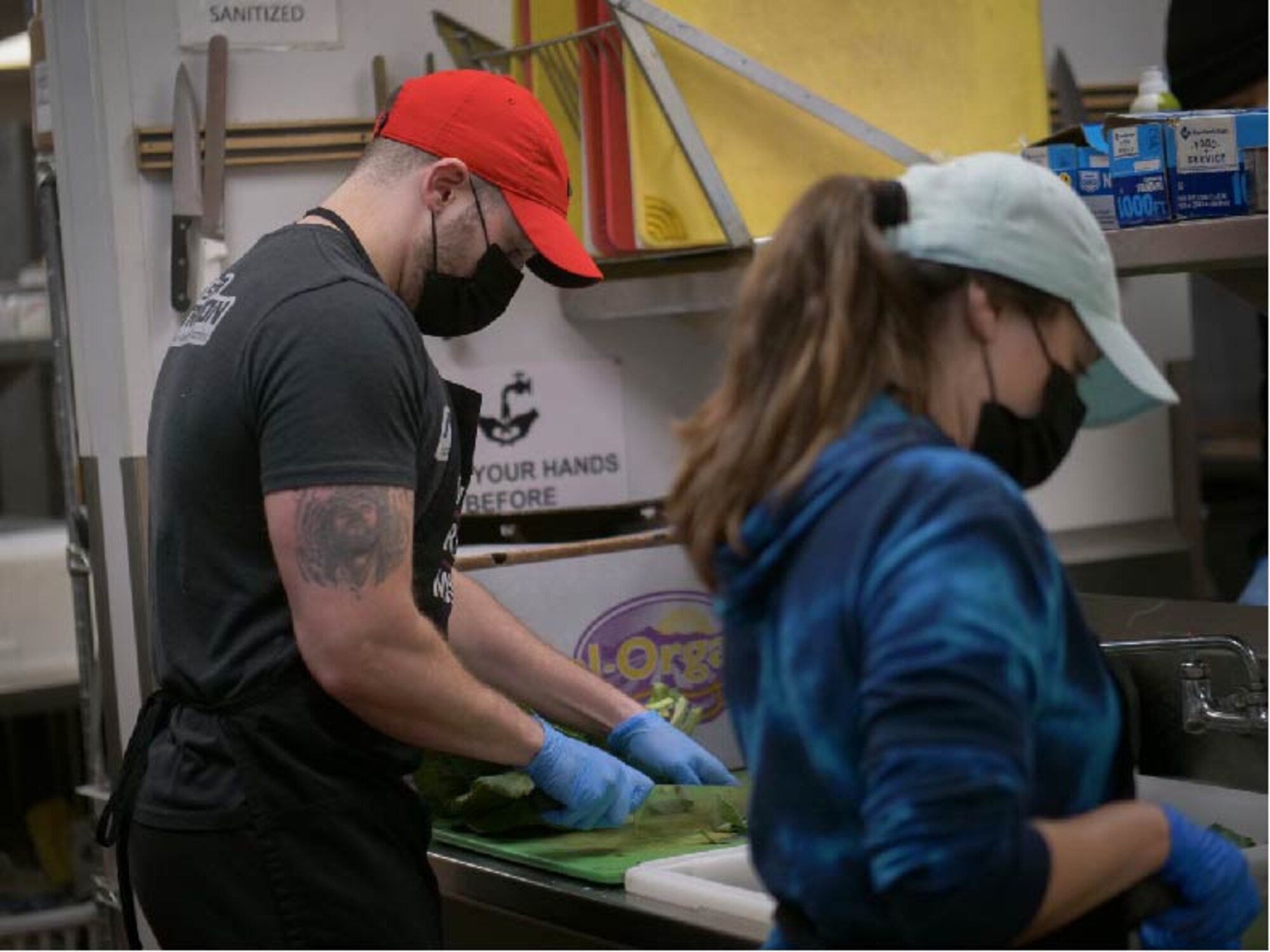 U.S. Air Force Staff Sgt. Jimmy Mrosko, an Air Guard and Reserve assignment technician, and his wife, Staff Sgt. Ashlee Sandefur, a Command Support Staff team member, both at Headquarters Air Reserve Personnel Center, prepares meals at Denver Rescue Mission Feb. 21, 2021, in Denver, Colo. Mrosko led the charge of developing a volunteer team from HQ ARPC in serving the 6,104 homeless persons of the Denver community on a bimonthly basis. (U.S. Air Force photo by Master Sgt. Leisa Grant/Released)