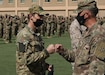 Norwegian Army 1st Lt. Havard Boge fist bumps Army Reserve Brig. Gen. Justin Swanson, the commanding general of the 310th Sustainment Command (Expeditionary) during the March 21, 2021 recognition ceremony at Camp Arifjan, Kuwait, for the 328 U.S. and coalition military personnel who earned the Norwegian Foot March badge. Boge, who represented the Norwegian Army at the ceremony, finished 18.6-mile course with a 25-pound ruck with the second fastest time when he crossed the finish line at 2 hours and 54 minutes. (U.S. Army photo by Staff Sgt. Neil W. McCabe)