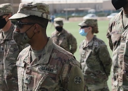 Army Reserve Sgt. Jeremie Cates, 310th Sustainment Command (Expeditionary), stands at parade rest at the March 21, 2021 recognition ceremony for the 328 U.S. and coalition military personnel who earned the Norwegian Foot March badge at Camp Arifjan, Kuwait. Cates earned his NFM badge when he completed the 18.6-mile course with a 25-pound ruck in 4 hours and 1 minute. (U.S. Army photo by Staff Sgt. Neil W. McCabe)