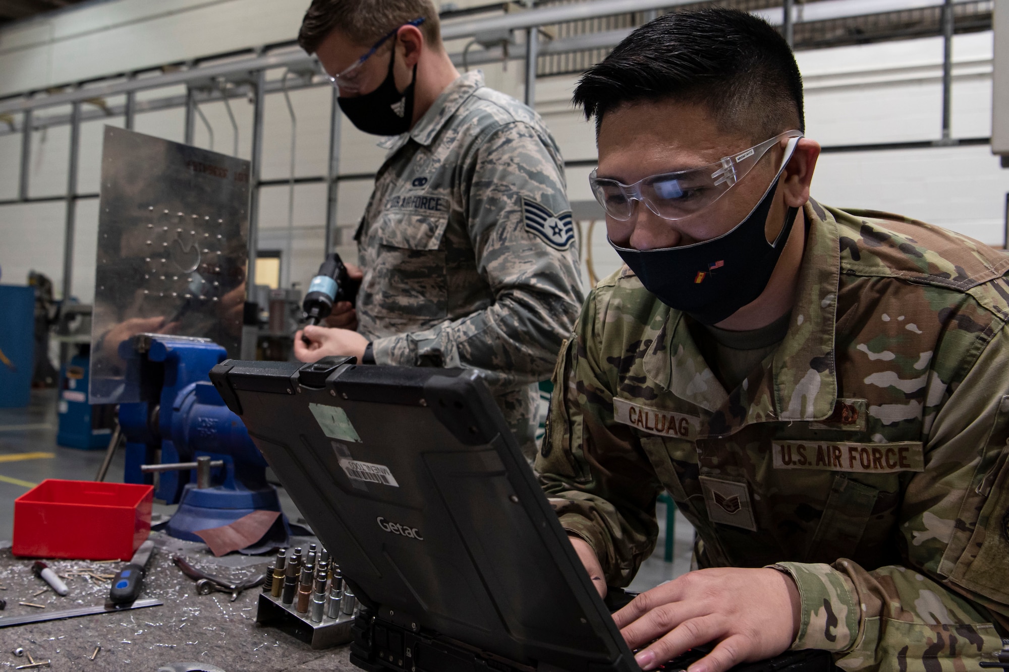 Photo of an Airman reading technical orders.