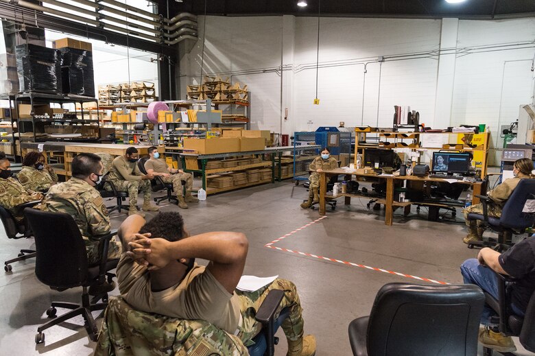 Members of the 436th Aerial Port Squadron packing and crating section watch a video during the one-day extremism standdown on Dover Air Force Base, Delaware, March 19, 2021. Secretary of Defense Lloyd J. Austin III directed the departmentwide standdown to discuss problems of extremism in the ranks and train members on taking appropriate action to combat extremism. (U.S. Air Force photo by Roland Balik)