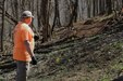 man points at biking trail