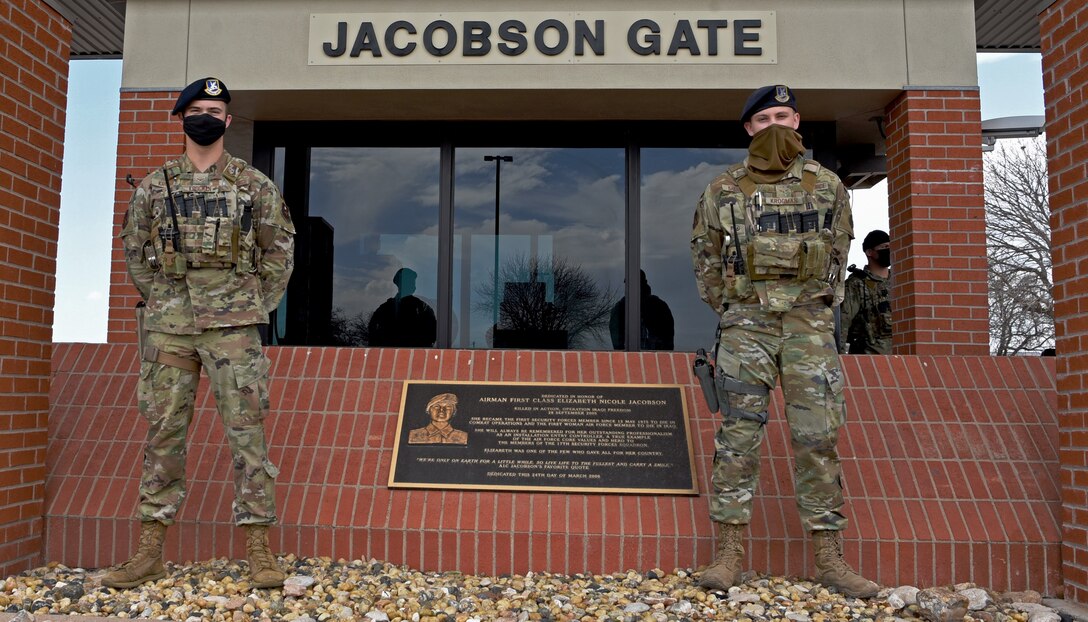 U.S. Air Force Airman 1st Class Brandon Krogman and Airman 1st Class Damian Krogman, 17th Security Forces Squadron installation entry controllers, are standing at the Jacobson Gate, on Goodfellow Air Force Base, Texas, March 16, 2021. Brandon and Damian are brothers, whose relationship created a driving force to cultivate an environment of accountability and excellence. (U.S. Air Force photo by Senior Airman Abbey Rieves)