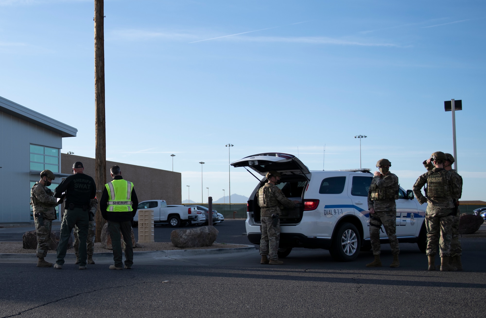 Airmen from the 56th Security Forces Squadron and officers from the Maricopa County Sheriff’s Office train on the scene of an exercise Feb. 26, 2021, at Luke Air Force Base, Arizona. Security forces, MCSO and the Glendale Police Department all participated in the exercise, which evaluated the training, readiness and capability of Luke Airmen to respond to an active shooter. At the conclusion of the exercise, a real-world threat was announced and every law enforcement member participating in the exercise rapidly transitioned to the integrated response. Exercises ensure Airmen meet warfighting needs with a continuous drive toward more effective and efficient training, sharpening their real-world skills. (U.S. Air Force photo by Staff Sgt. Amber Carter)