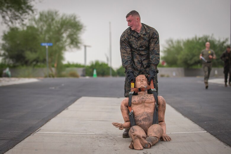 U.S. Marines with Headquarters and Headquarters Squadron (H&HS), run through a fireman training obstacle course in Yuma, Ariz., Sep. 11, 2020. The obstacle course training event was created and ran as part of a squadron memorial honoring the events of 9/11. (U.S. Marine Corps photo by Lance Cpl. John Hall)