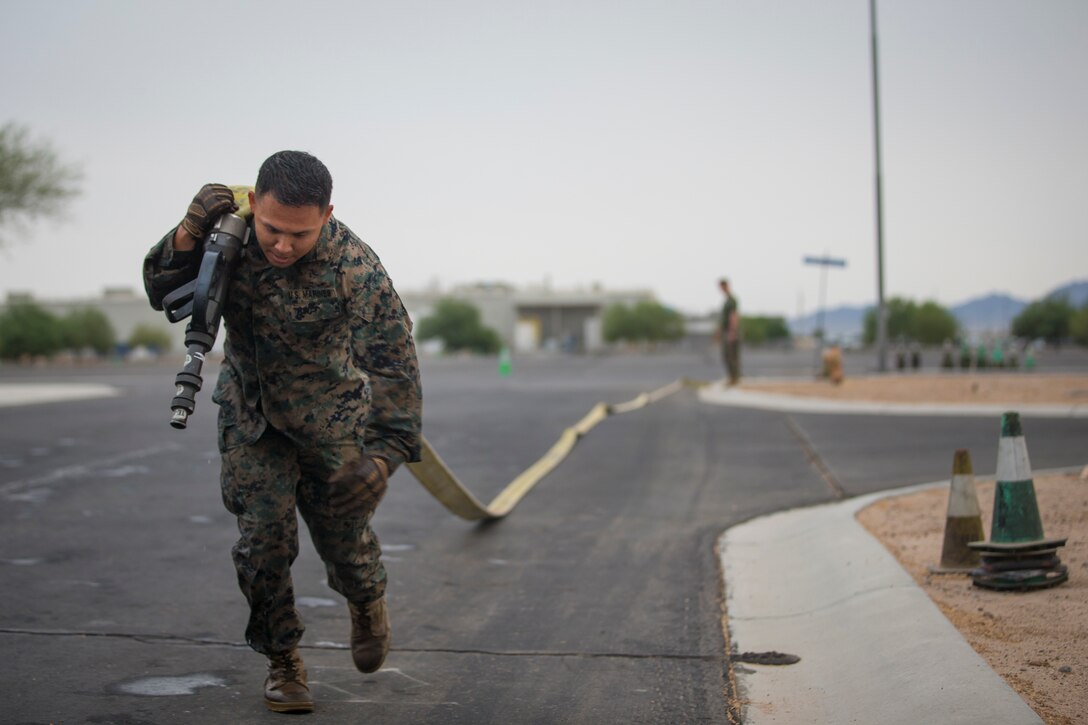 U.S. Marines with Headquarters and Headquarters Squadron (H&HS), run through a fireman training obstacle course in Yuma, Ariz., Sep. 11, 2020. The obstacle course training event was created and ran as part of a squadron memorial honoring the events of 9/11. (U.S. Marine Corps photo by Lance Cpl. John Hall)