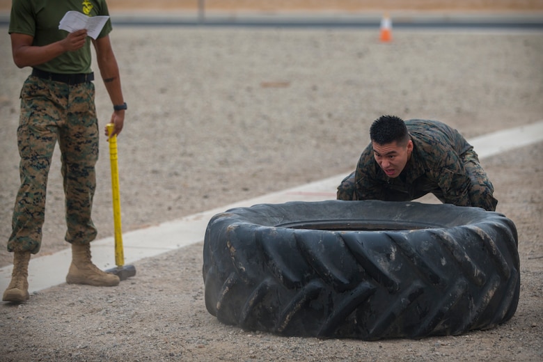U.S. Marines with Headquarters and Headquarters Squadron (H&HS), run through a fireman training obstacle course in Yuma, Ariz., Sep. 11, 2020. The obstacle course training event was created and ran as part of a squadron memorial honoring the events of 9/11. (U.S. Marine Corps photo by Lance Cpl. John Hall)