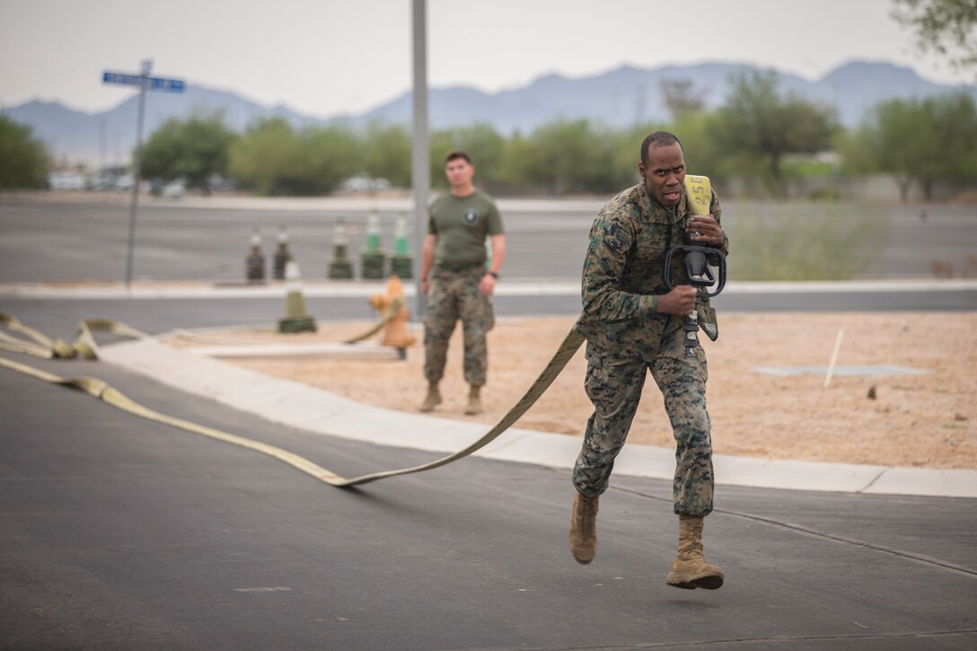 U.S. Marines with Headquarters and Headquarters Squadron (H&HS), run through a fireman training obstacle course in Yuma, Ariz., Sep. 11, 2020.