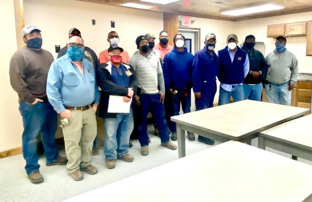 IN THE PHOTO, a team of mechanics, electricians, carpenters, pipefitters, HVAC technicians, and revetment workers all got together to completely renovate the Tractor Shop’s breakroom, literally from the ground up.