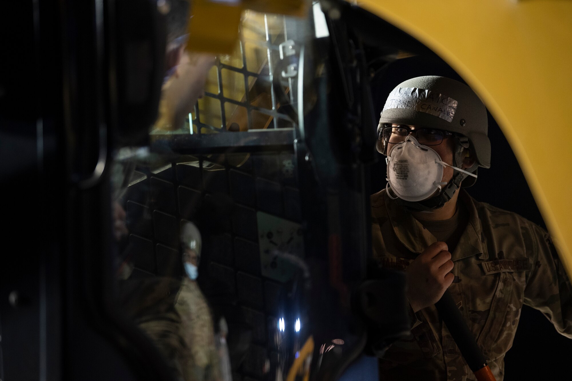 U.S. Air Force Airman 1st Class Jamie Canales, 52nd Civil Engineer Squadron Rapid Airfield Damage Recovery team member, coordinates runway repair operations with a heavy machinery operator during the AGILE SABRE exercise on Spangdahlem Air Base, Germany, March 23, 2021.
