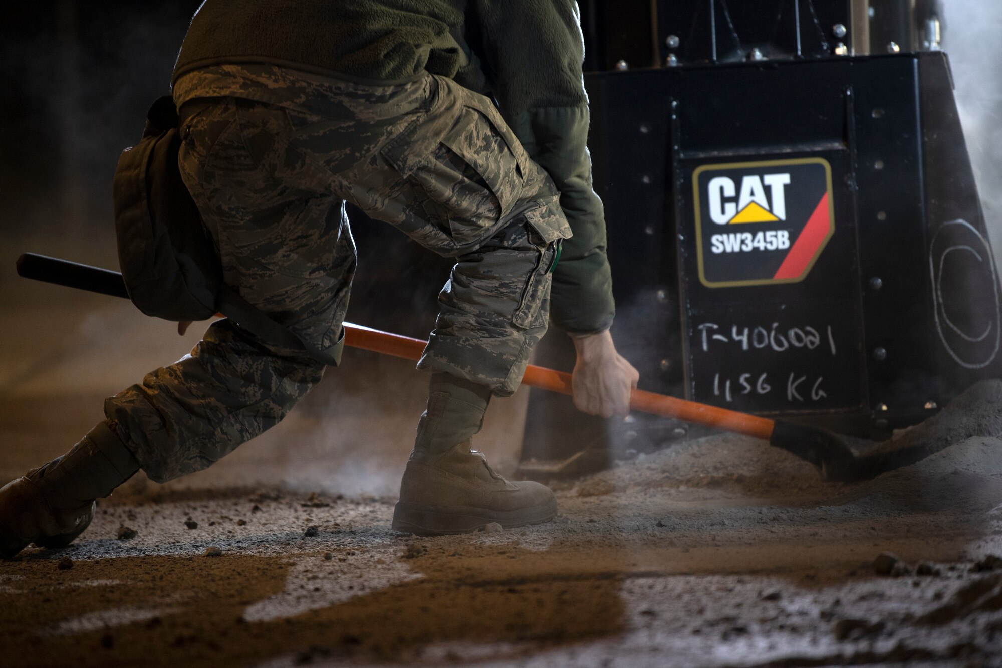 A U.S. Air Force Airman from the 52nd Civil Engineer Squadron’s Rapid Airfield Damage Recovery team shovels debris during runway repair operations as part of the AGILE SABRE exercise on Spangdahlem Air Base, Germany, March 23, 2021.