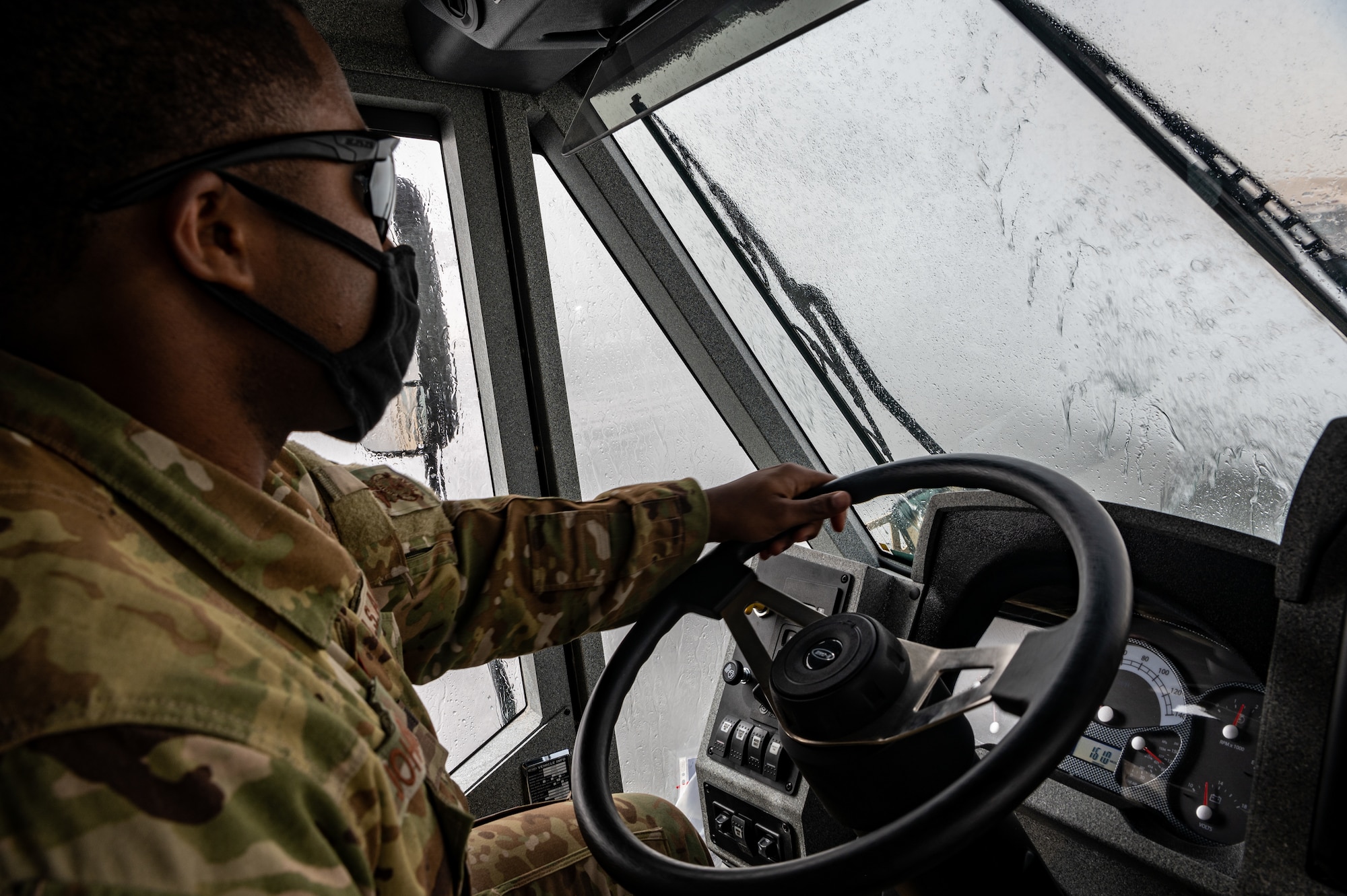 A firefighter drives a firetruck