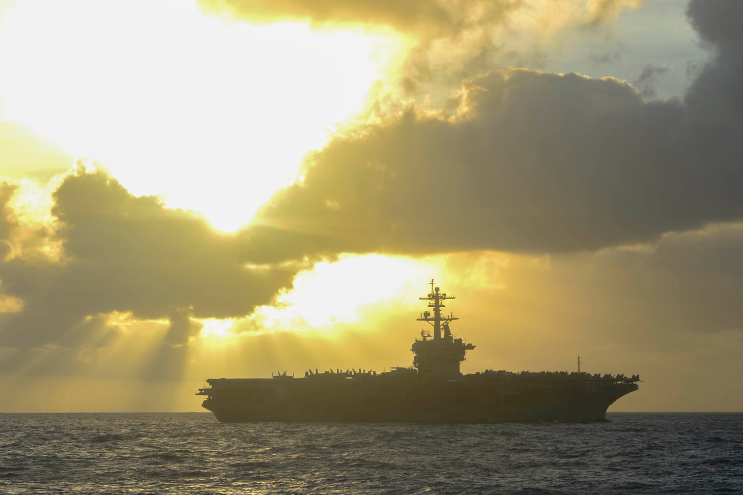 An aircraft carrier floats on the sea.