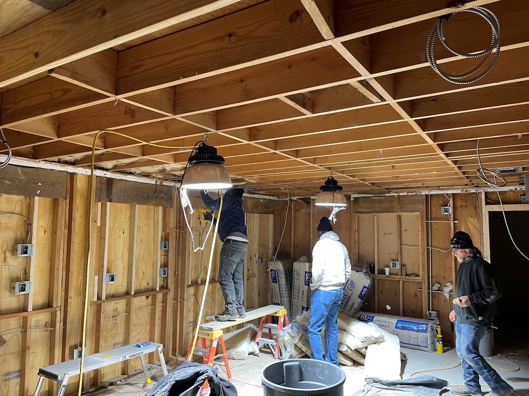 IN THE PHOTO, a team of mechanics, electricians, carpenters, pipefitters, HVAC technicians, and revetment workers all got together to completely renovate the Tractor Shop’s breakroom, literally from the ground up.