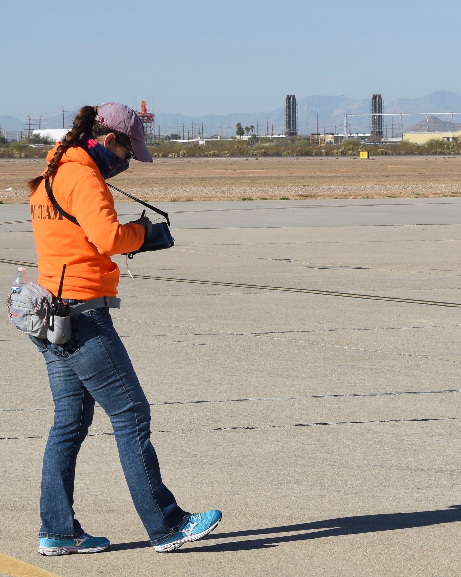 A picture of a woman walking with tablet