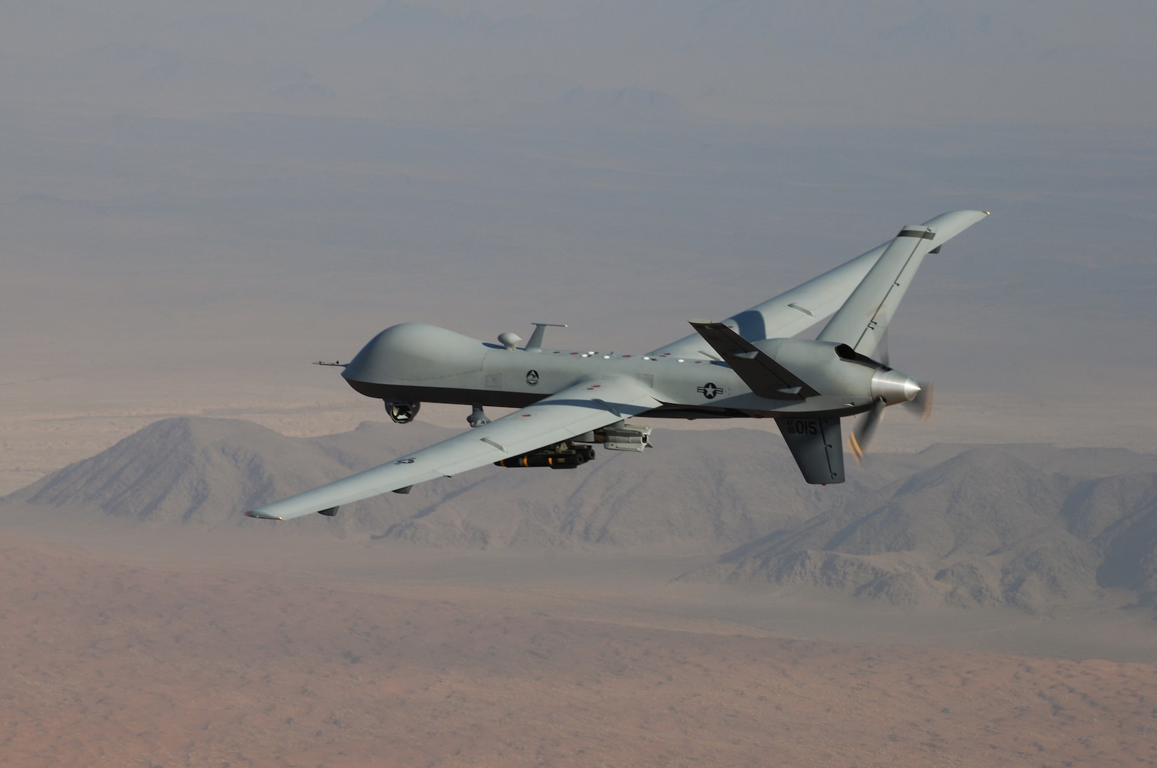 An MQ-9 Reaper, armed with GBU-12 Paveway II laser guided munitions and AGM-114 Hellfire missiles, piloted by Col. Lex Turner flies a combat mission over southern Afghanistan. (U.S. Air Force Photo / Lt. Col. Leslie Pratt)