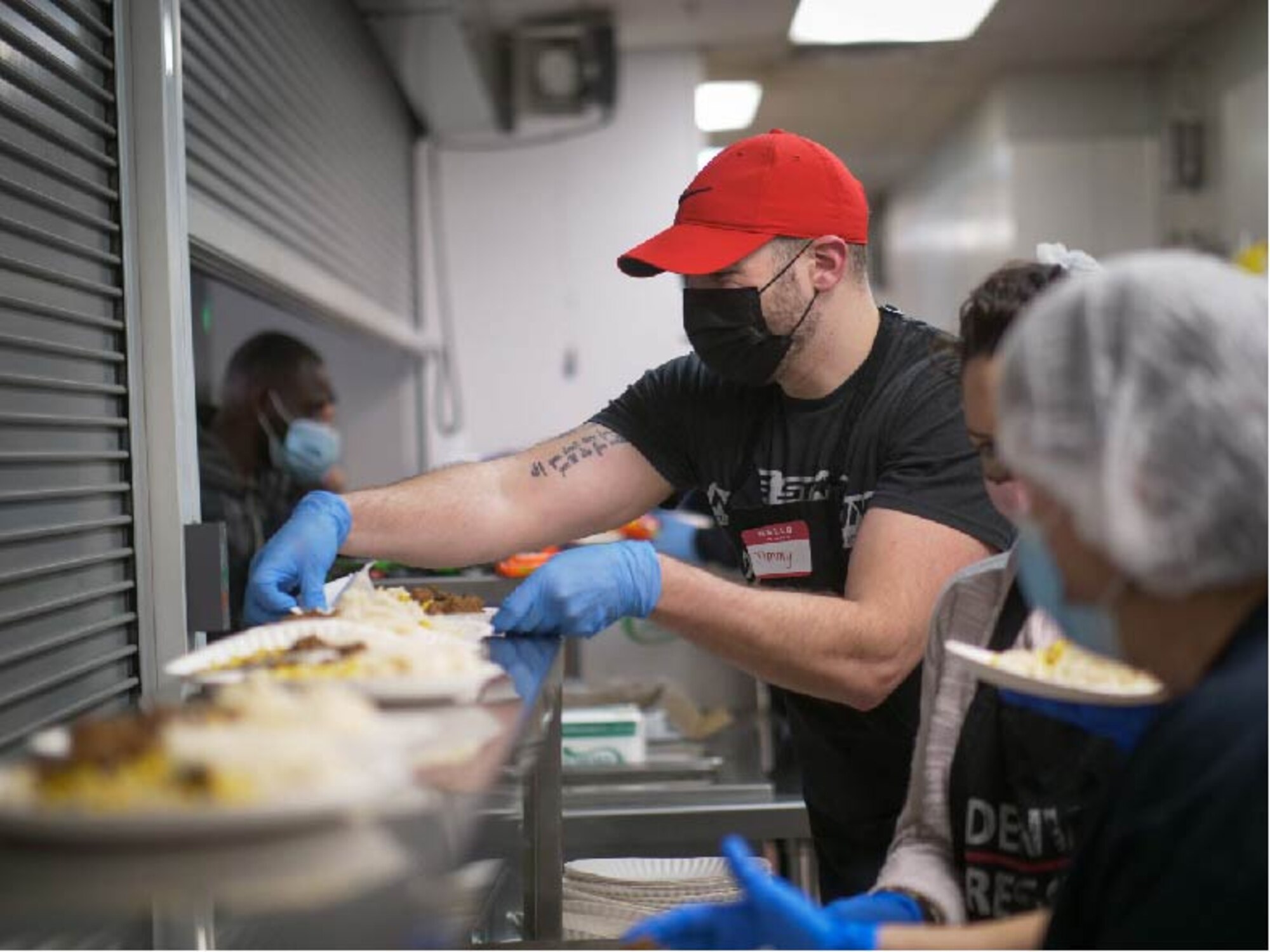 U.S. Air Force Staff Sgt. Jimmy Mrosko, an Air Guard Reserve assignment technician at Headquarters Air Reserve Personnel Center, prepares meals at Denver Rescue Mission Feb. 21, 2021, in Denver, Colo. Mrosko said, “these people are going through hard times, but I see the joy in their spirit.” (U.S. Air Force photo by Master Sgt. Leisa Grant/Released)
