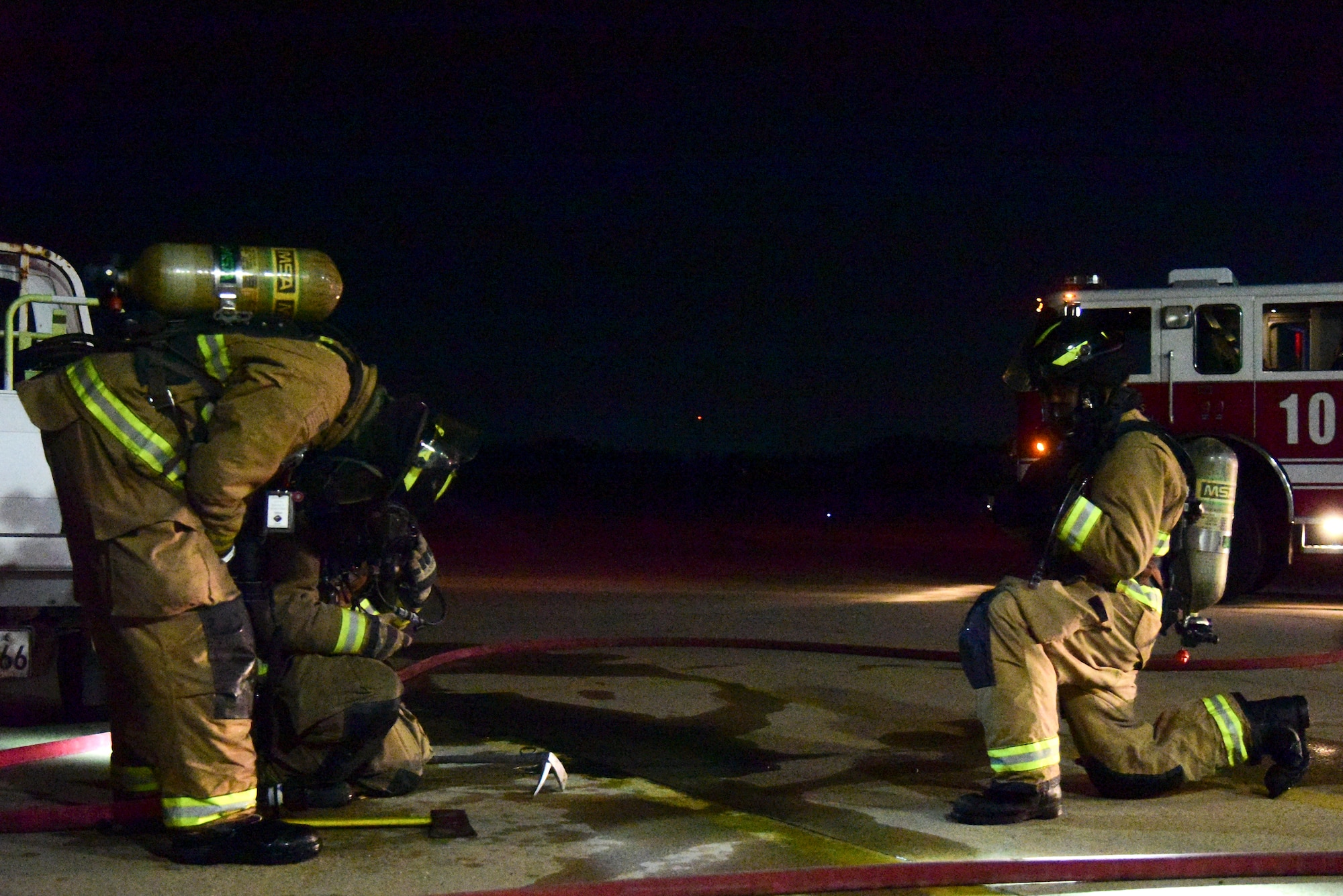 Eighth Civil Engineer Squadron firefighters catch their breath after a training exercise at Kunsan Air Base, Republic of Korea, March 23, 2021. Firefighters respond to emergencies from brush fires to burning rocket fuel and hazardous material fires to ensure the safety of others. (U.S. Air Force photo by Senior Airman Suzie Plotnikov)