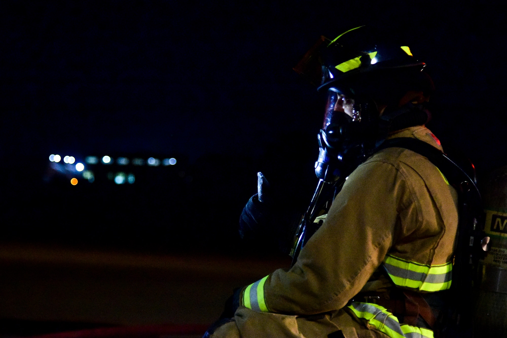 Senior Airman Orlando Teel, 8th Civil Engineer Squadron firefighter, catches his breath after a training exercise at Kunsan Air Base, Republic of Korea, March 23, 2021. Firefighters respond to emergencies from brush fires to burning rocket fuel and hazardous material fires to ensure the safety of others. (U.S. Air Force photo by Senior Airman Suzie Plotnikov)