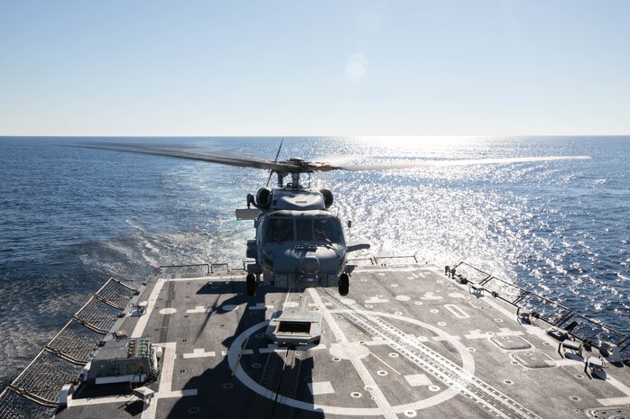 A MH-60R Seahawk helicopter, attached to the Helicopter Maritime Strike Squadron (HSM) 79, departs the flight deck of the Arleigh Burke-class guided-missile destroyer USS Roosevelt (DDG 80), March 23, 2021.