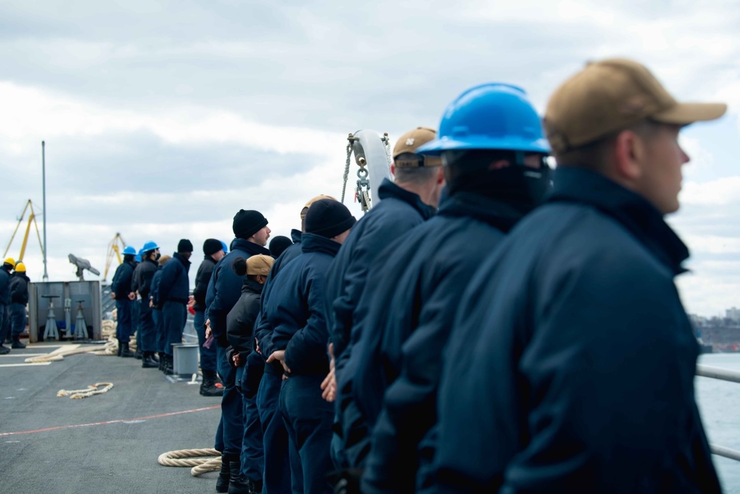 210323-N-WQ732-3010 CONSTANTA, Romania (March 23, 2021) Sailors man the rails as the Ticonderoga-class guided-missile cruiser USS Monterey (CG 61) departs Constanta, Romania, March 23, 2021.  Monterey is operating with the IKE Carrier Strike Group on a routine deployment in the U.S. Sixth Fleet area of operations in support of U.S. national interests and security in Europe and Africa. (U.S. Navy photo by Mass Communication Specialist Seaman Chelsea Palmer/Released)