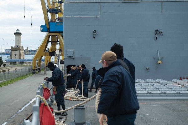 210323-N-WQ732-1052 CONSTANTA, Romania (March 23, 2021) Sailors pull mooring lines aboard as the Ticonderoga-class guided-missile cruiser USS Monterey (CG 61) prepares to depart from Constanta, Romania, March 23, 2021.  Monterey is operating with the IKE Carrier Strike Group on a routine deployment in the U.S. Sixth Fleet area of operations in support of U.S. national interests and security in Europe and Africa. (U.S. Navy photo by Mass Communication Specialist Seaman Chelsea Palmer/Released)