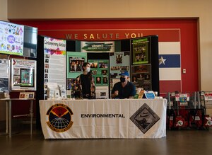 Members of the Environmental Team wait at their table for World Water Day.