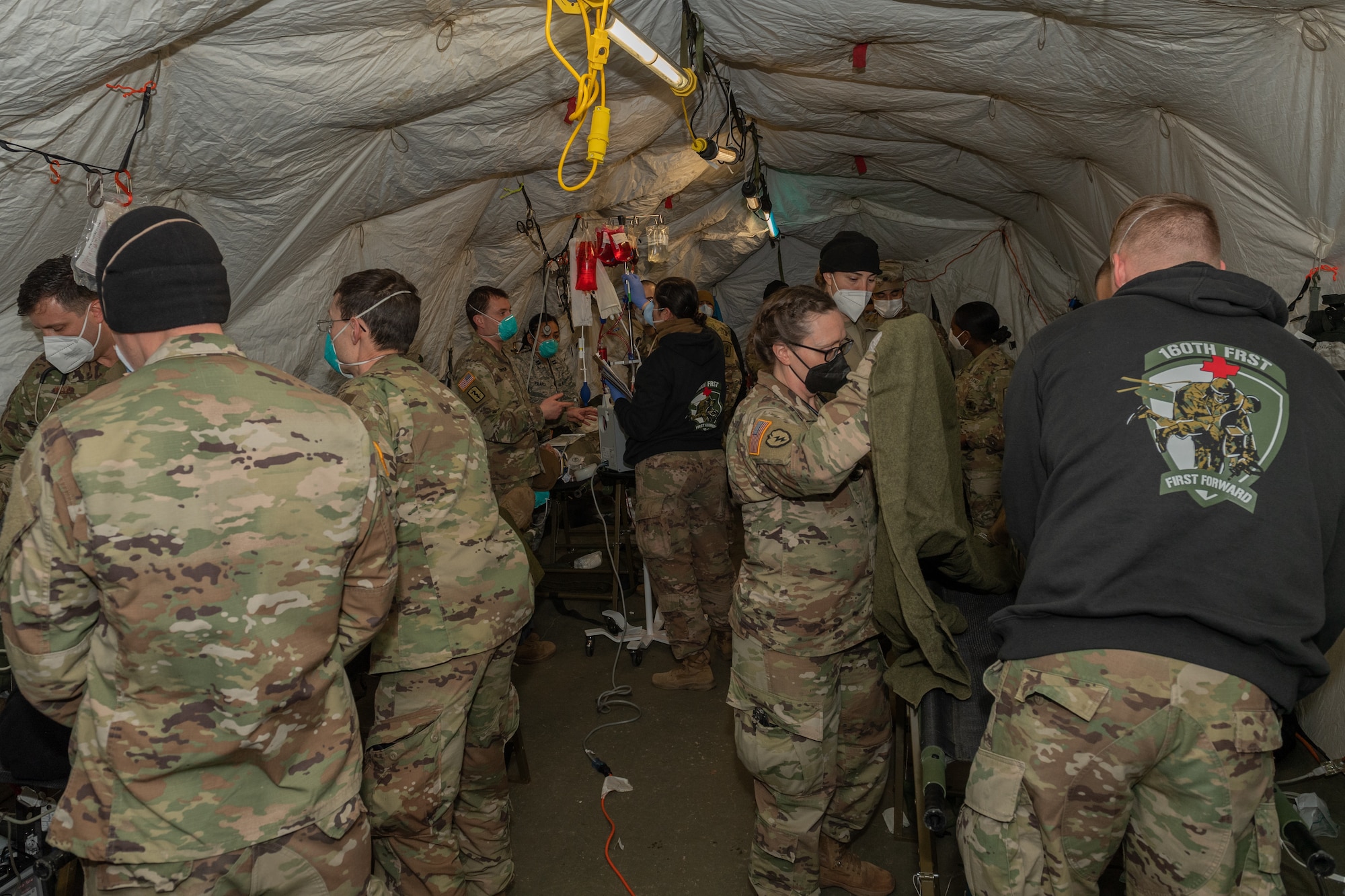 Medical personnel working in an emergency room tent.