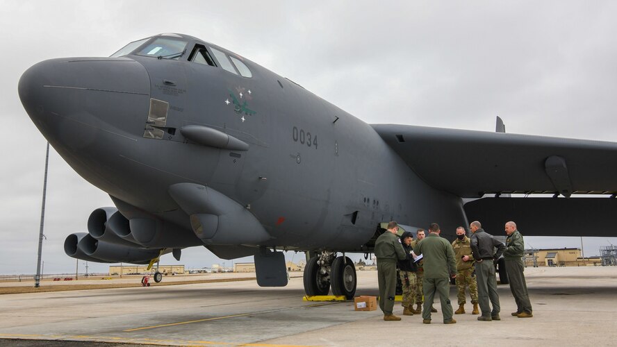 The flight crew of the B52 Stratofortress "Wise Guy" converse in front of the bomber at Minot Air Force Base, North Dakota March 23, 2021.