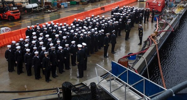 Sailors assigned to the guided missile cruiser USS Gettysburg (CG 64) stand in formation during a change of command ceremony.