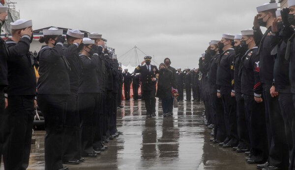 Sailors assigned to the guided-missile cruiser USS Gettysburg (CG 64) render honors to departing former commanding officer Capt. Corey Keniston after a change of command ceremony.