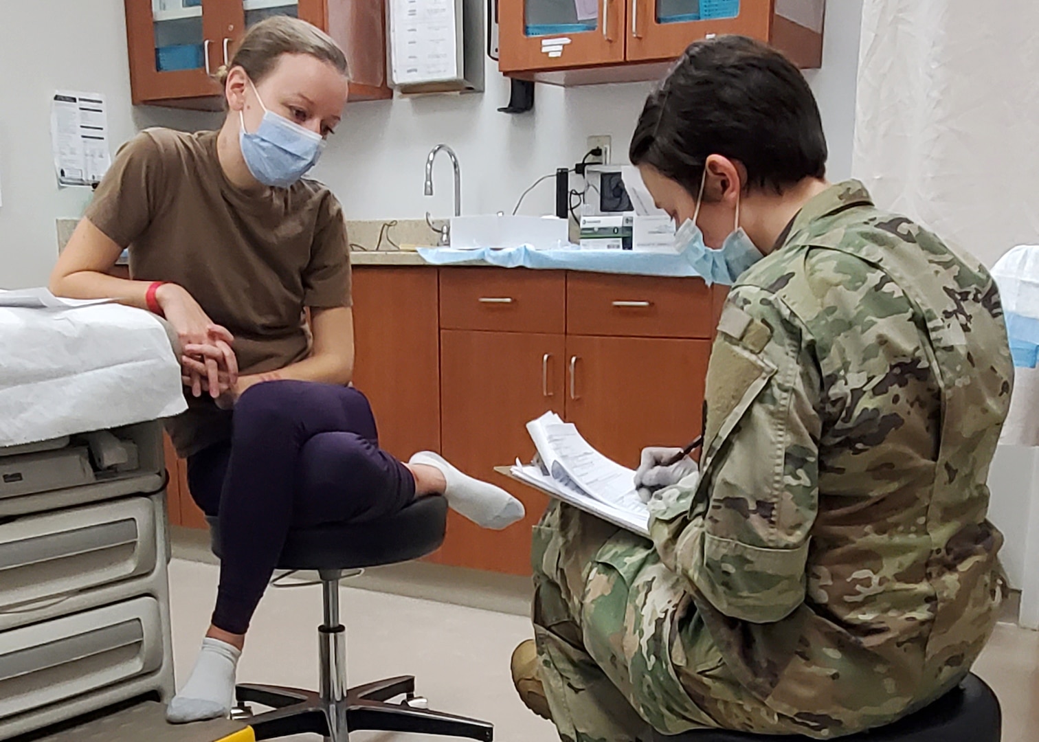 U.S. Navy Lt. Ann Lehto conducts a simulated sexual assault forensic examination interview of a role player during a Sexual Assault Medical Forensic Examiner course hosted on Fort Drum.