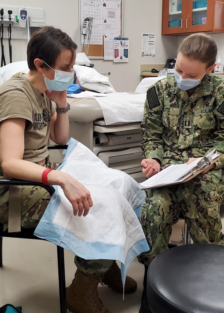U.S. Navy Lt. Ann Lehto performs the role of a sexual assault victim during the practical training portion of the Sexual Assault Medical Forensic Examiner course hosted on Fort Drum