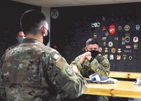 Col. Michael Walters, Commander of the 5th Bomb Wing, converses with airmen at Minot Air Force Base, North Dakota March 24, 2021.