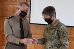 Maj. Gen. Timothy P. Williams, the adjutant general of Virginia, presents a coin to Maj. Bridget Flannery, South Dakota National Guard SHARP Master Trainer and developer of Buddy Aid, March 2, 2021, at the State Military Reservation in Virginia Beach, Virginia. The training on “Buddy Aid – First Response to Sexual Assault” was sponsored by the office of the Virginia National Guard Sexual Assault Response Coordinator and included military and civilians from National Guard Bureau’s Sexual Assault Prevention and Response Office, Delaware, Maryland, Tennessee, Washington, D.C., and Virginia.