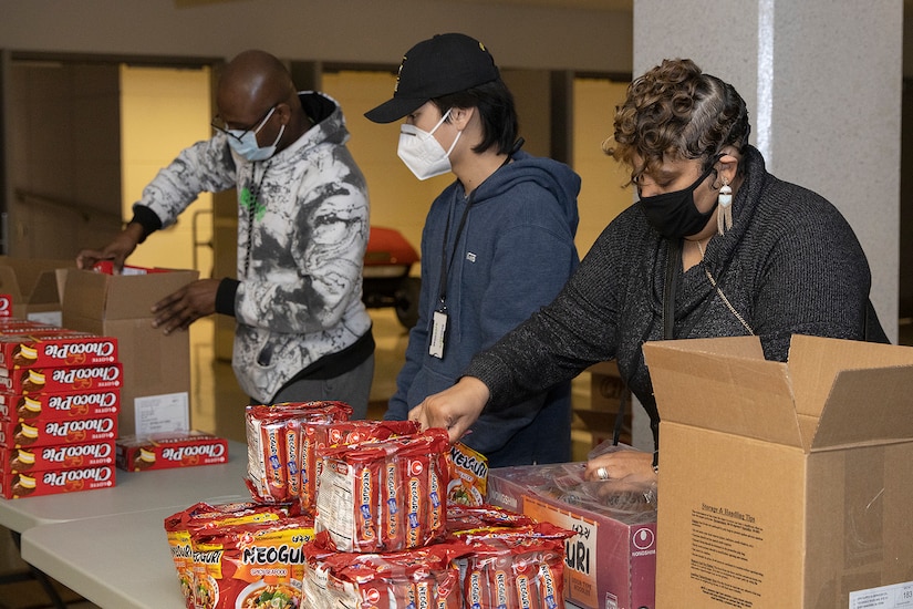 Shani Adams-Houston, right, wife of Ronald Houston, U.S. Army Financial Management Command Army Military Pay Office site captain, load up Soldier care packages at the Maj. Gen. Emmett J. Bean Federal Center in Indianapolis March 6, 2021. Houston joined Army Soldiers, civilian employees, veterans and retirees to make care packages, which will be sent to deployed Soldiers of the U.S. Army Reserve’s 310th Expeditionary Sustainment Command. (U.S. Army photo by Mark R. W. Orders-Woempner)