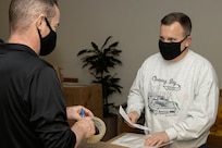 Brig. Gen. Mark S. Bennett, U.S. Army Financial Management Command, right, coordinates with Mark Sullivan, USAFMCOM Army Financial Services senior financial manager, as they label Soldier care packages at the Maj. Gen. Emmett J. Bean Federal Center in Indianapolis March 6, 2021. Bennett and Sullivan joined other Army Soldiers, civilian employees, veterans and retirees to make care packages, which will be sent to deployed Soldiers of the U.S. Army Reserve’s 310th Expeditionary Sustainment Command. (U.S. Army photo by Mark R. W. Orders-Woempner)